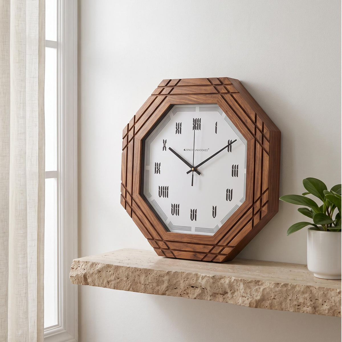 Octagonal wall clock with carved wooden groove frame and Roman numerals on white dial