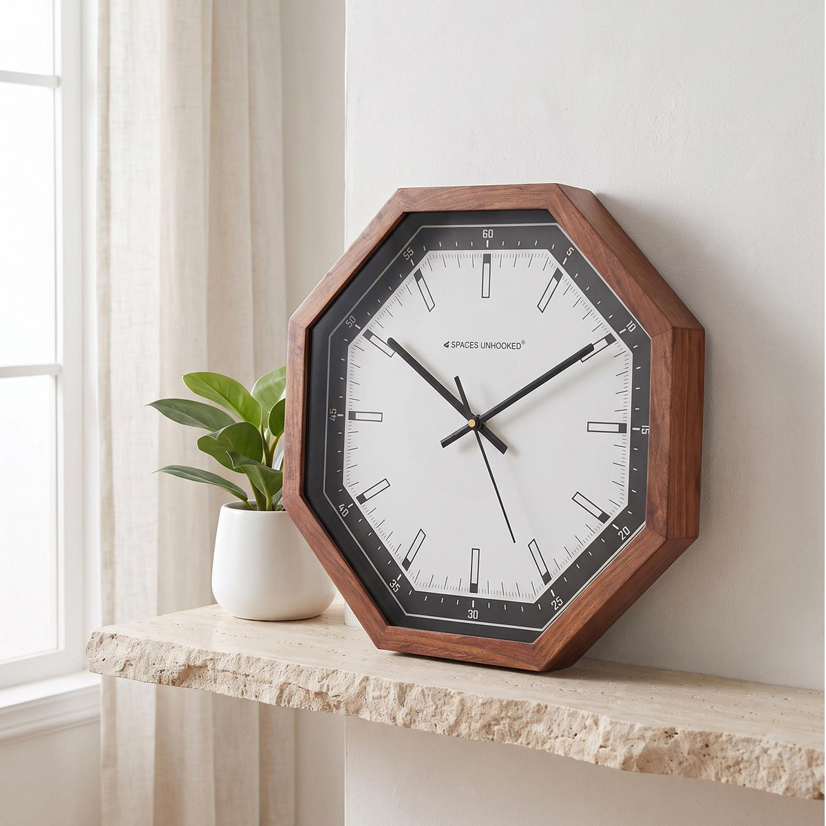 Spaces Unhooked octagonal wooden wall clock with black bezel and white dial, front view