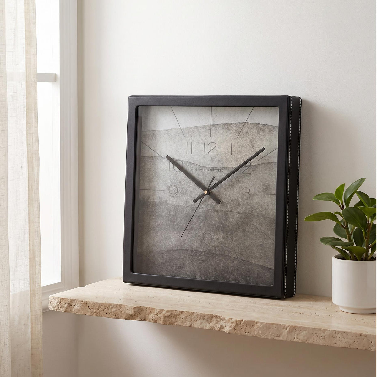 Square black wall clock with ash grey watercolour dial and faint numerals, front view