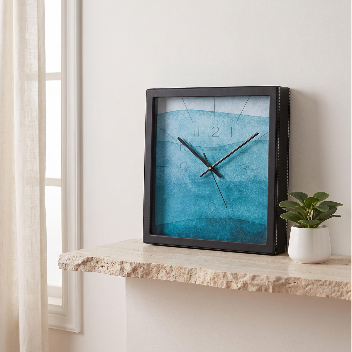Square black wall clock with teal and turquoise watercolour dial, front view