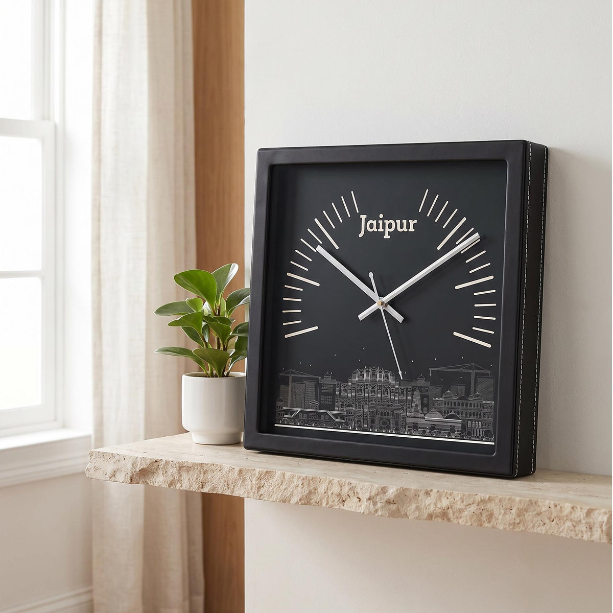 Square black wall clock with Jaipur skyline art on a deep green dial, front view