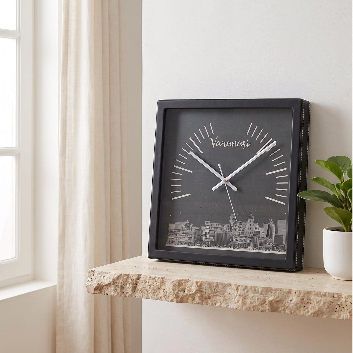 Square black wall clock with Varanasi skyline art on a charcoal dial, front view