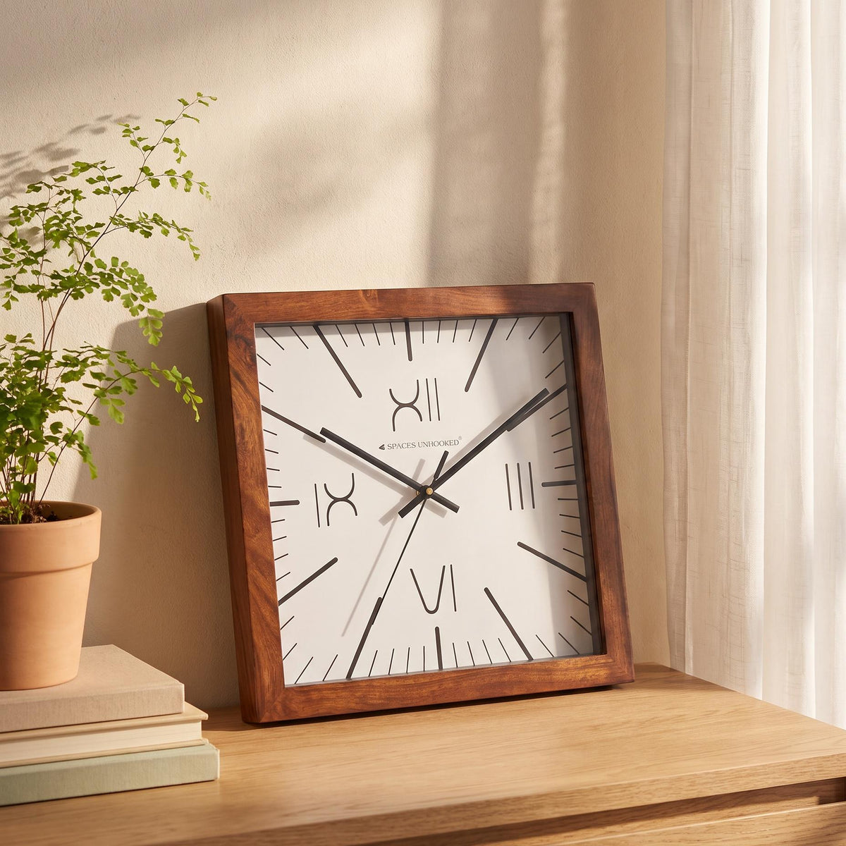 Spaces Unhooked four Roman numeral square wooden wall clock with white dial, front view