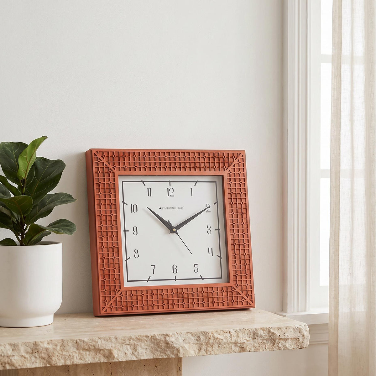 Square wall clock with terracotta lattice frame and slim numerals on white dial