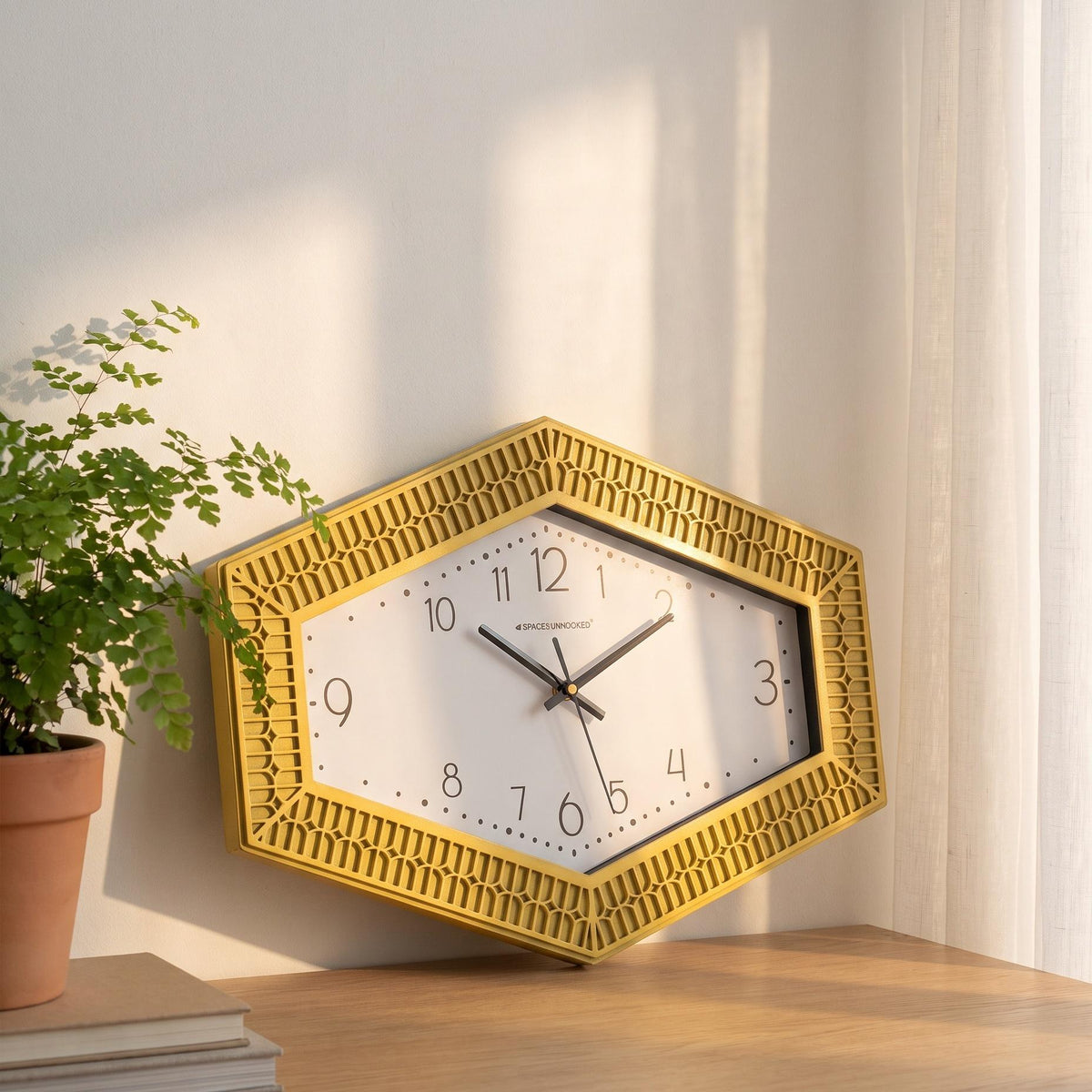 Spaces Unhooked logo above the brass-toned centre cap on a hexagonal yellow dial