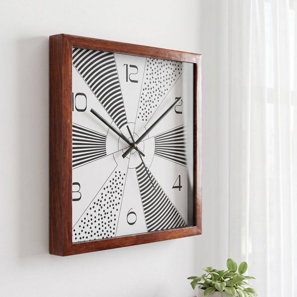 Geometric dial wooden wall clock on a minimal wall with terracotta and teal accents