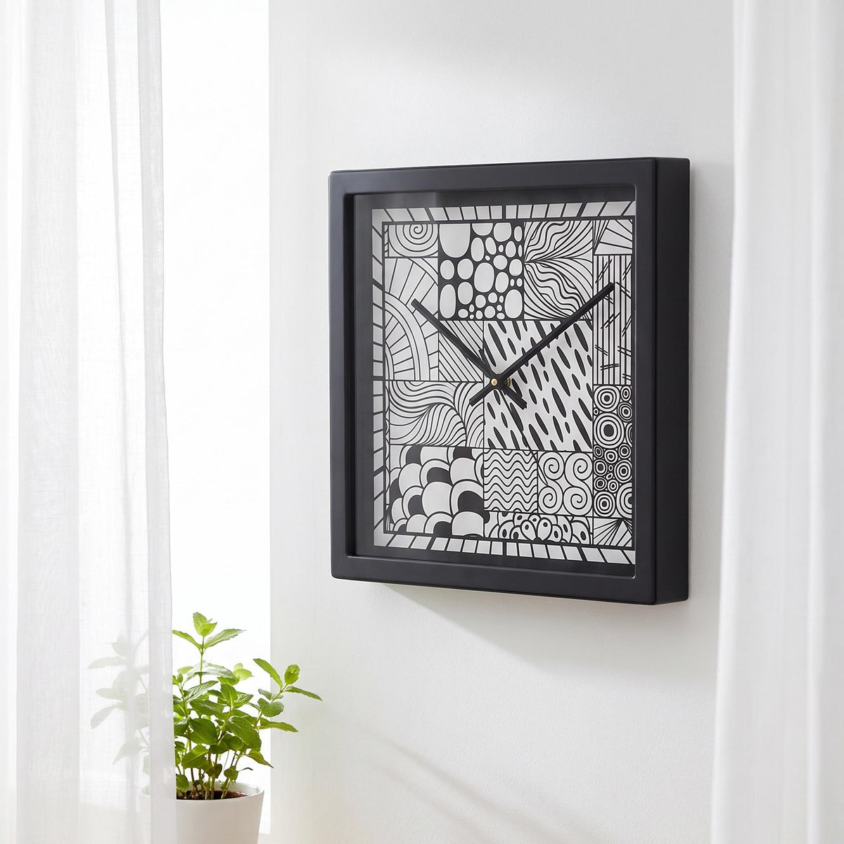 Doodle art wall clock on a hallway gallery wall with prints