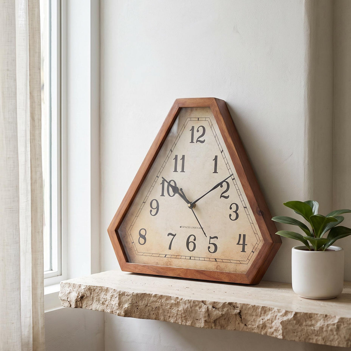Spaces Unhooked vintage triangular wooden wall clock with antique parchment-style dial, front view