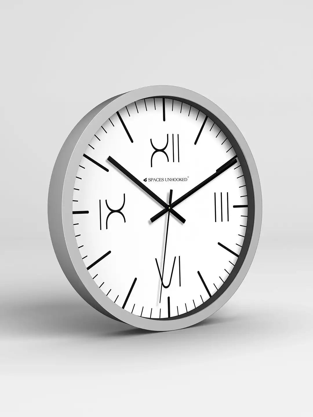 Wall clock with silver frame and white face on a light gray background