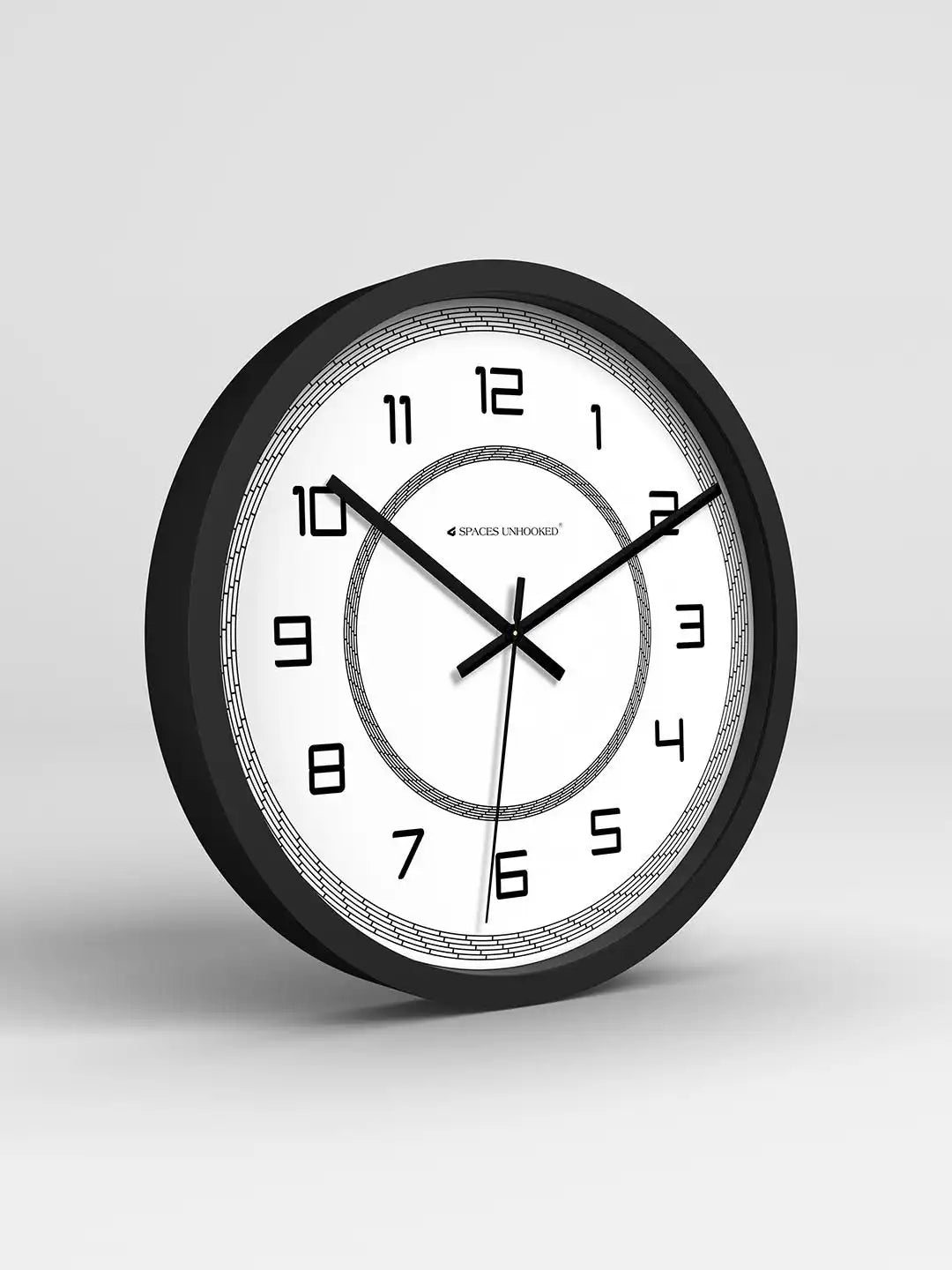 Wall clock with black frame and white face on a light gray background