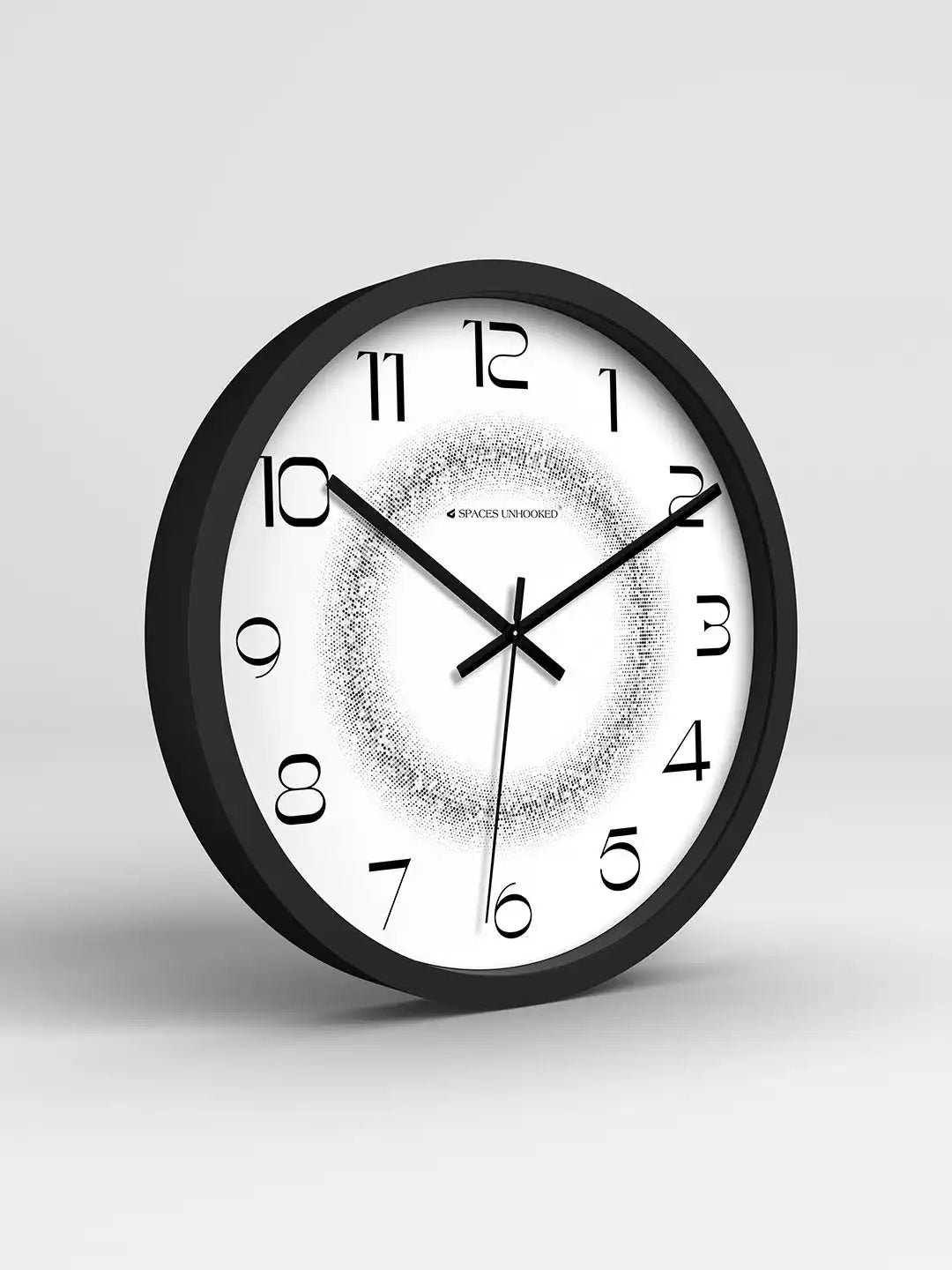 Black-framed clock with stylized numerals and a halftone-dot gradient center showing 10:11, angled against a plain gray background.