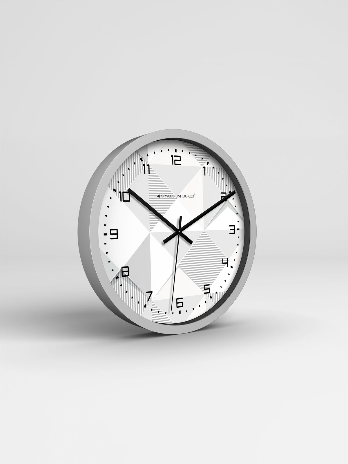 Round wall clock with a silver frame and white face on a light gray background