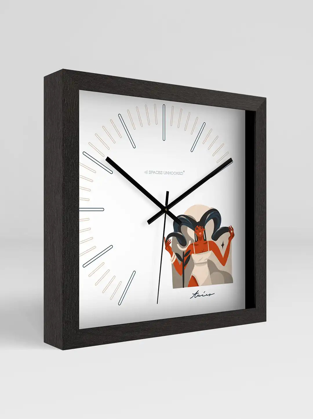 Close-up angled view of the Taurus zodiac wall clock featuring a black wooden frame, minimalist hour markers, and sleek black metal hands on a white dial.
