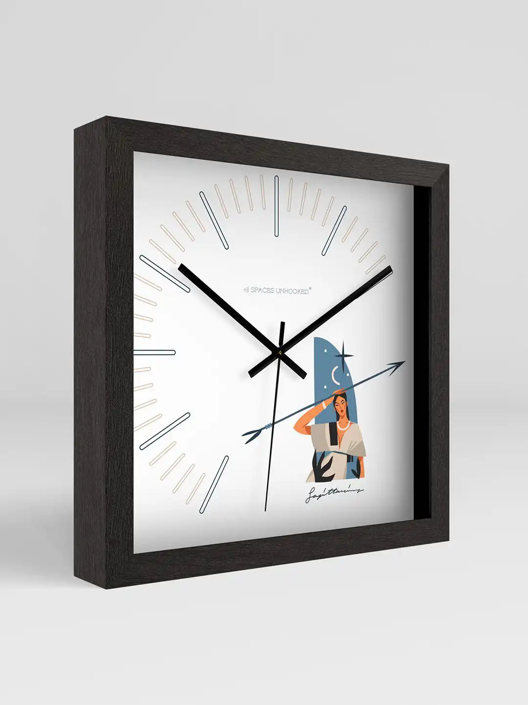 Sagittarius zodiac wall clock displayed beside its branded Spaces Unhooked packaging box, featuring a black wooden frame, minimalist dial design, and artistic Sagittarius illustration.