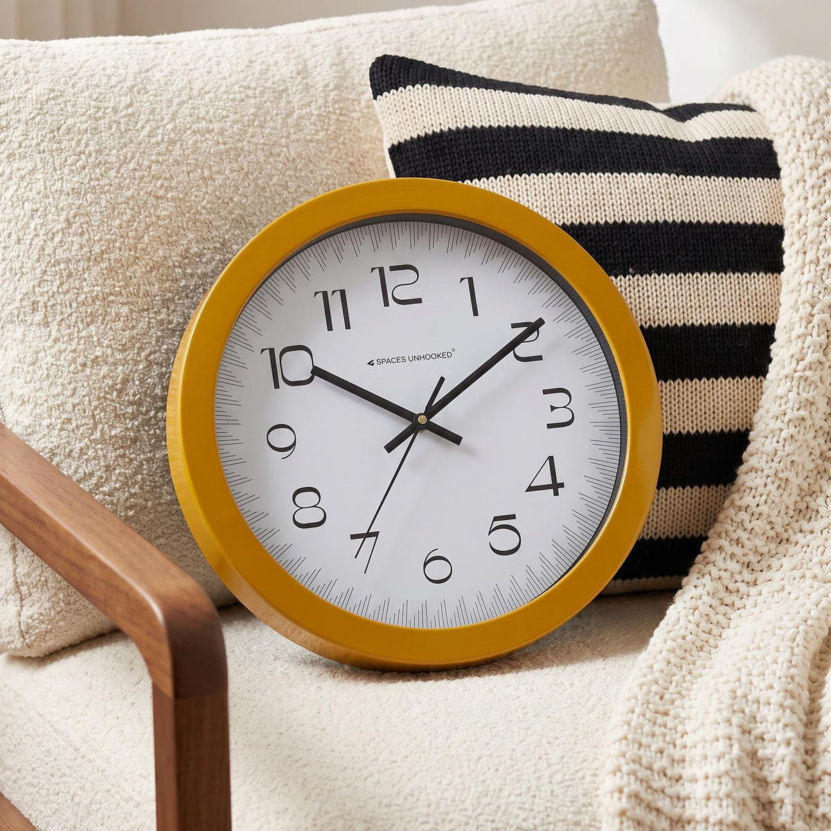 Mustard yellow round frame with a smooth finish around a white dial, close-up view