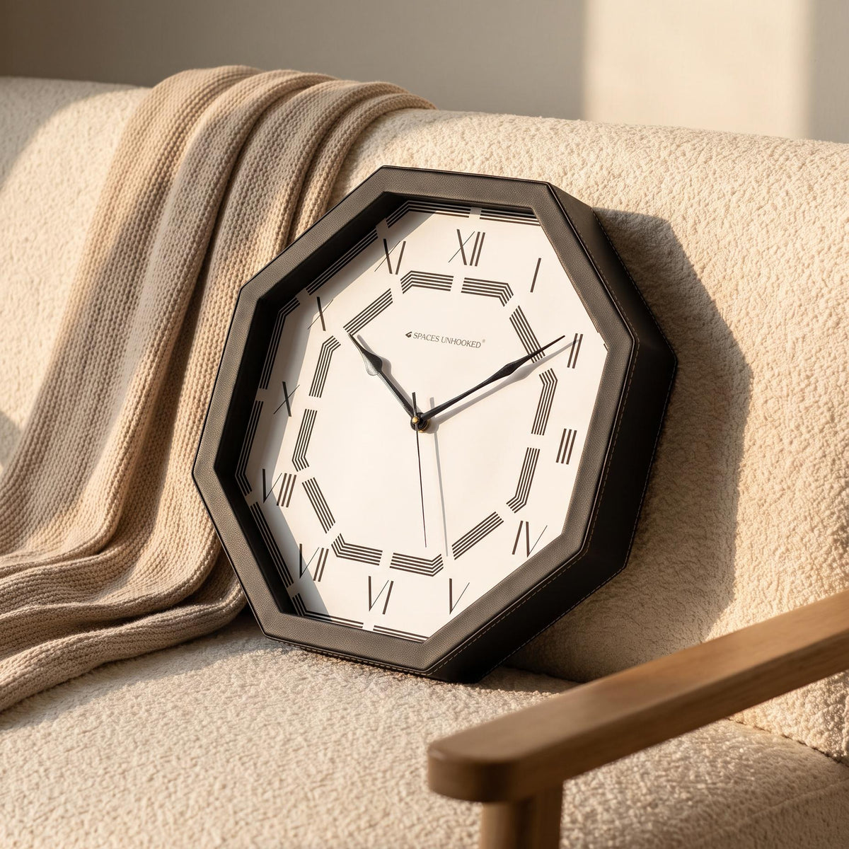 Octagonal Roman numeral wall clock above a console table in an entrance hall
