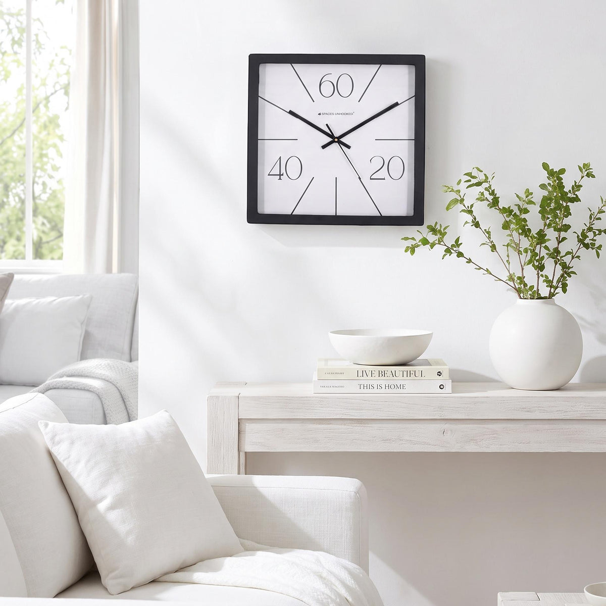 Spaces Unhooked logo above the brass-toned centre cap on a radial line clock dial