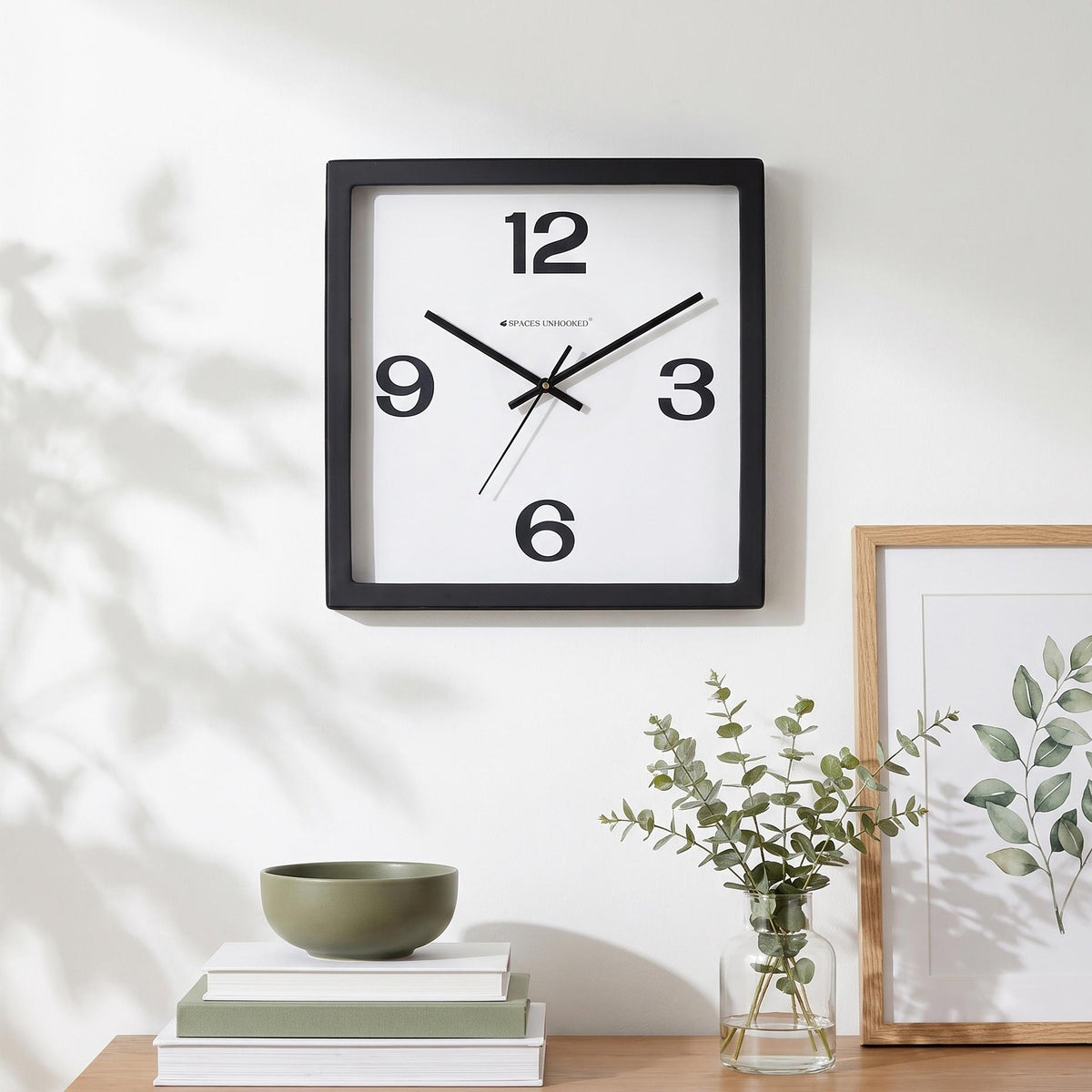 Spaces Unhooked logo above the brass-toned centre cap on a bold 12-3-6-9 clock dial