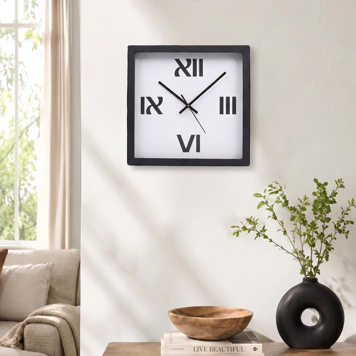 Spaces Unhooked logo above the brass-toned centre cap on a bold Roman numeral clock dial