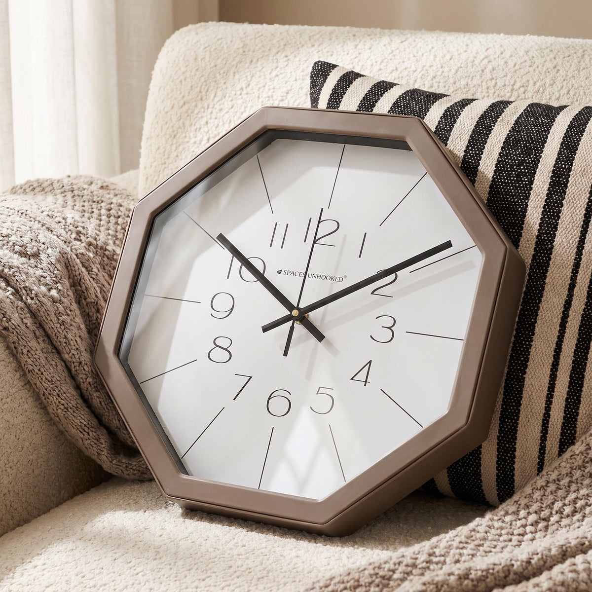 Warm taupe octagonal frame with a smooth finish and angled corners, close-up view