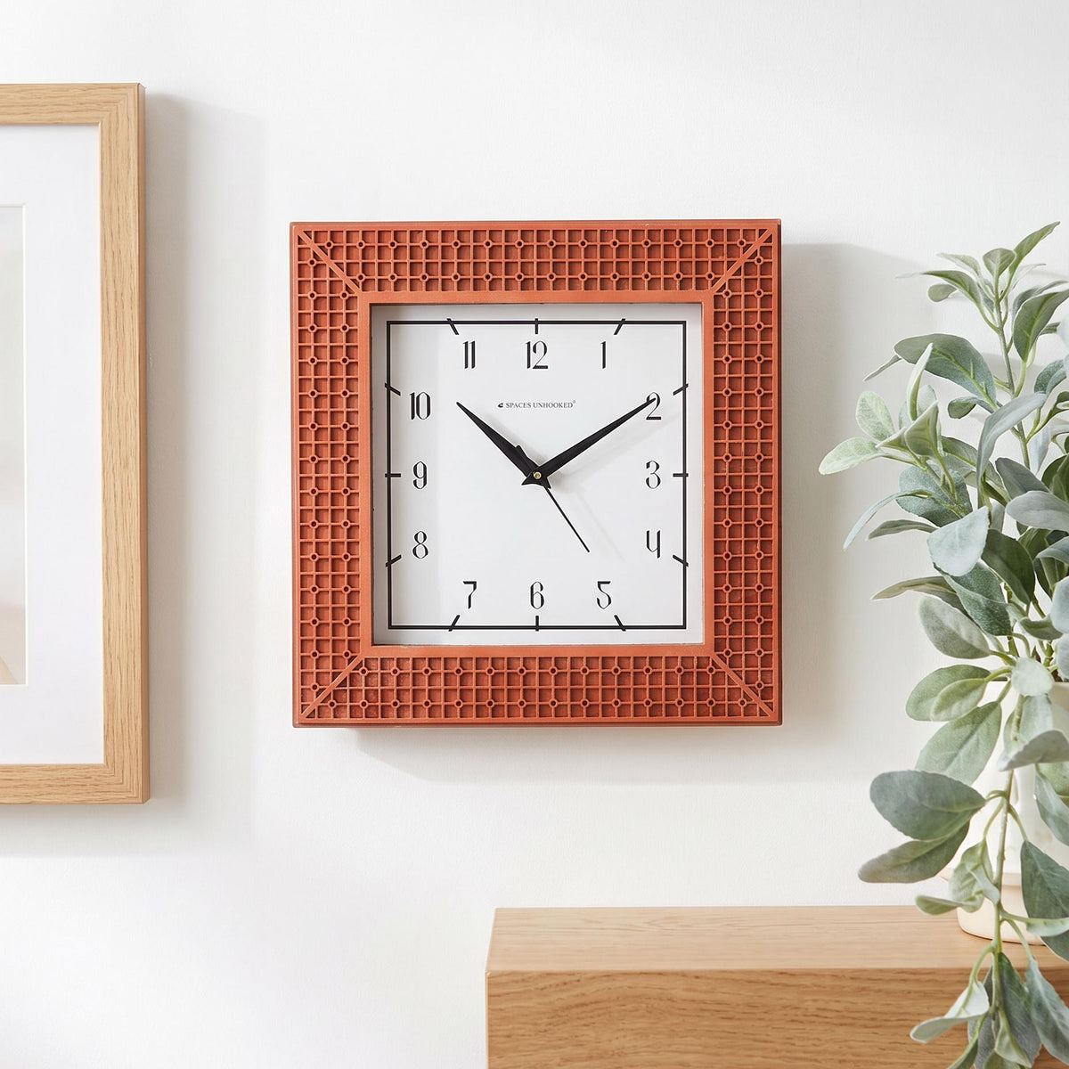 Close-up of the terracotta frame with a raised grid and circle pattern