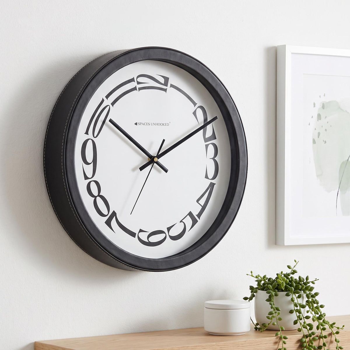 Spaces Unhooked Round Wall Clock, Melting Warped Numerals, Black Frame