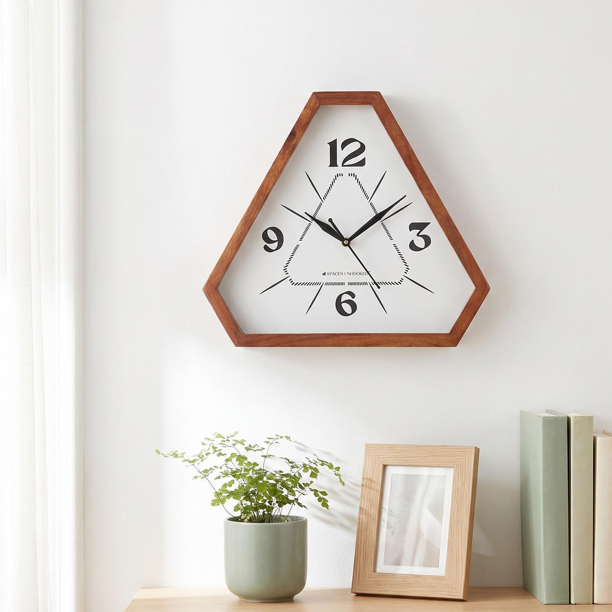 Reddish-brown triangular wooden frame with natural grain and clipped corners, close-up view