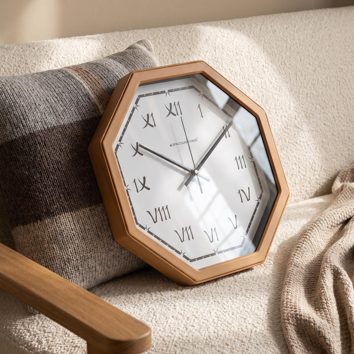 Warm terracotta octagonal frame with angled corners around a white dial, close-up view