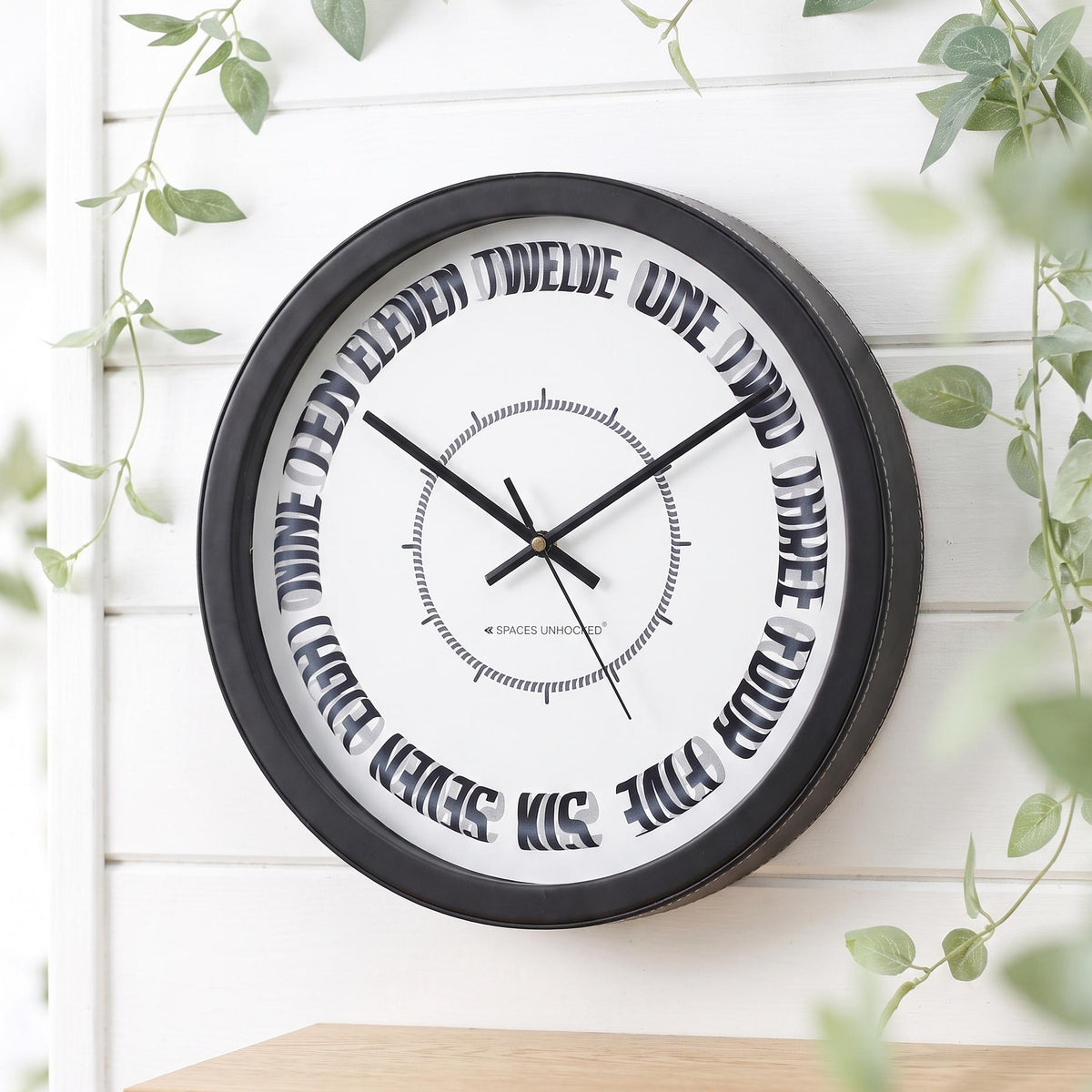 Spaces Unhooked Round Wall Clock, Curved Number Words, Black Frame