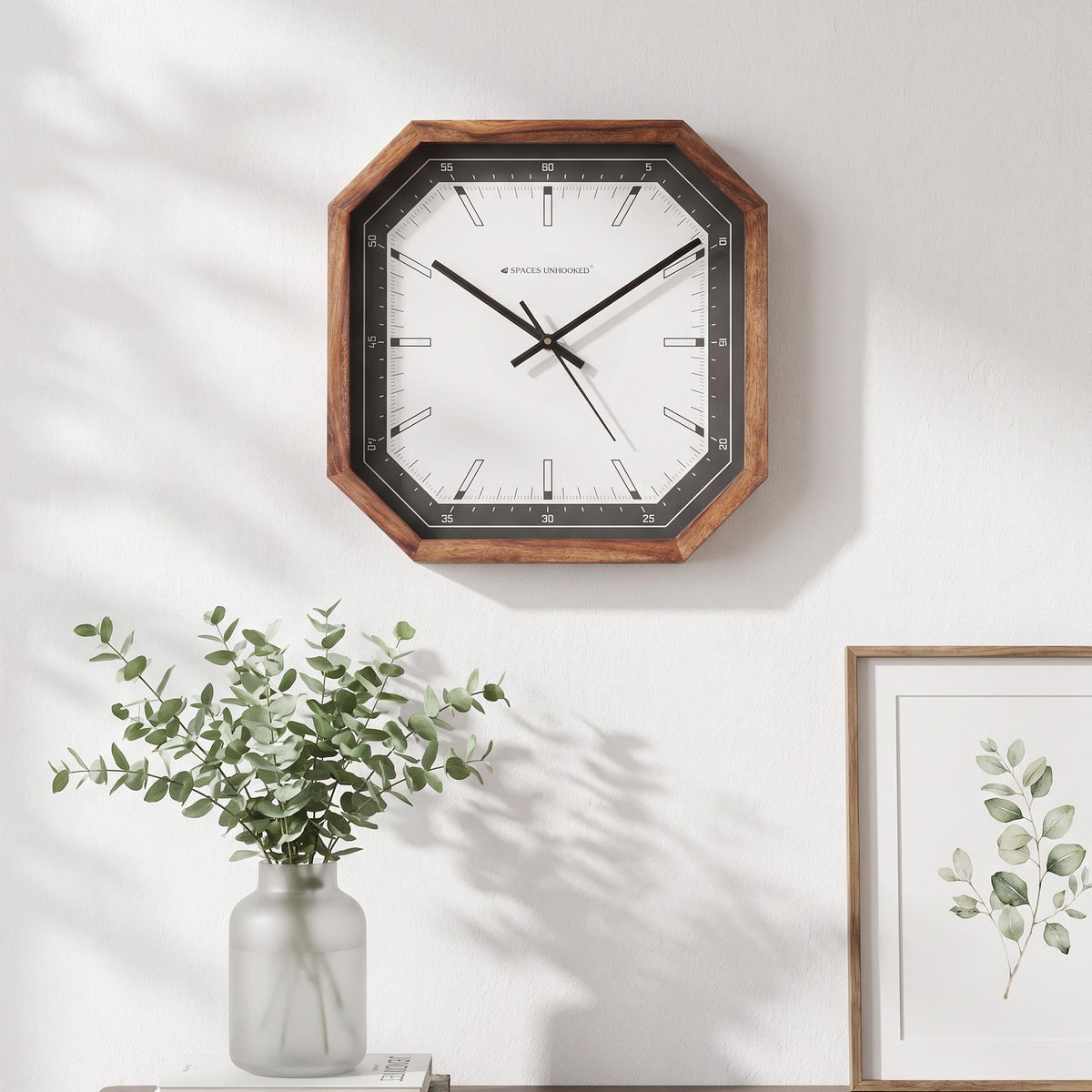 Long black hands and thin second hand across the bar markers of an octagonal wooden wall clock