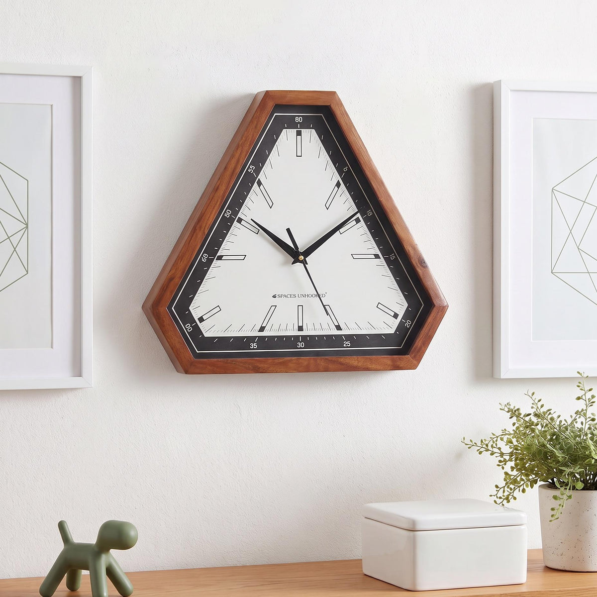 Warm brown triangular wooden frame with natural grain around a black bezel, close-up view