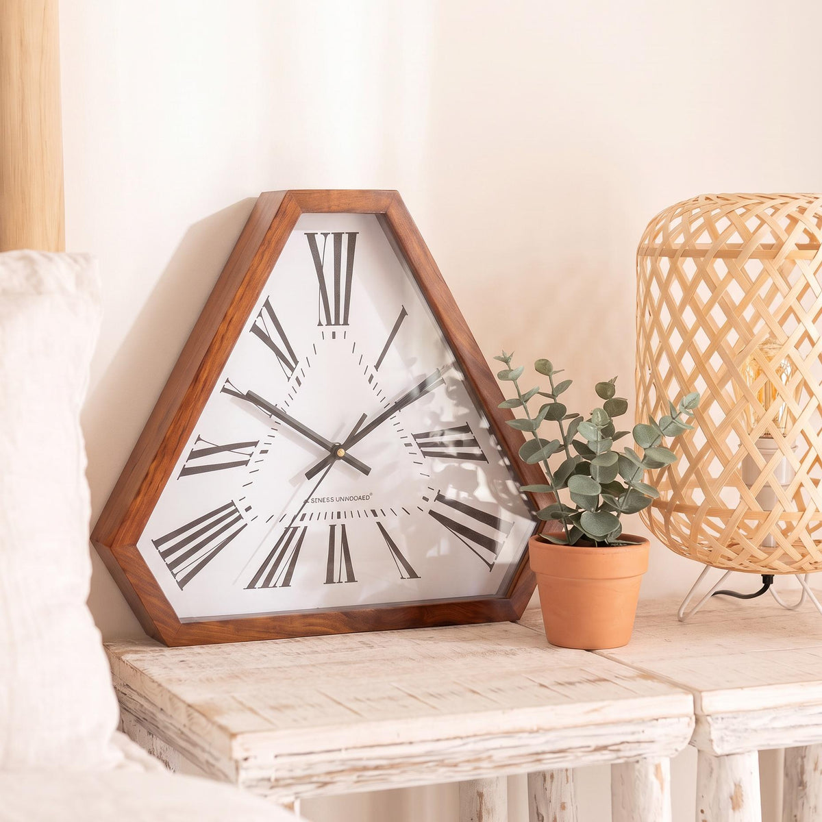 Warm reddish-brown triangular wooden frame with visible grain and clipped corners, close-up