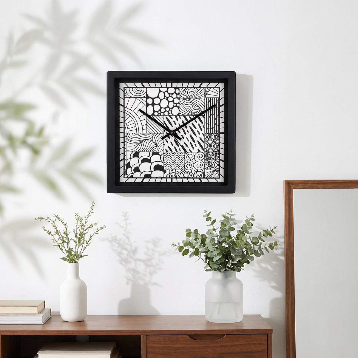 Spaces Unhooked logo above the brass-toned centre cap on a doodle art clock dial