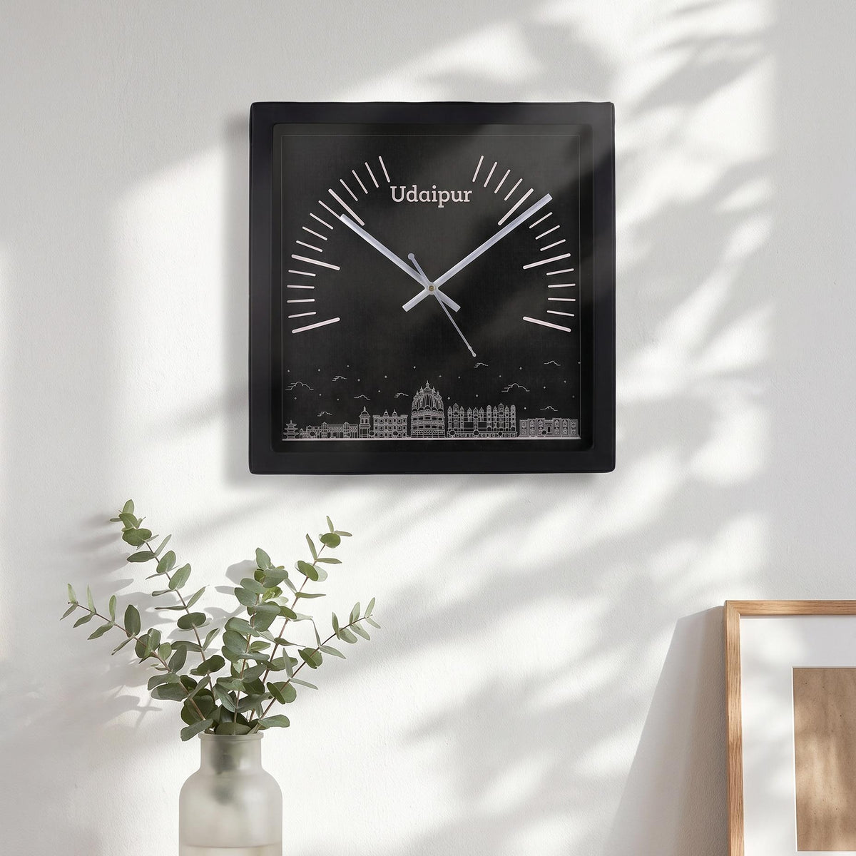 Spaces Unhooked logo above the brass-toned centre cap on a Udaipur skyline clock dial