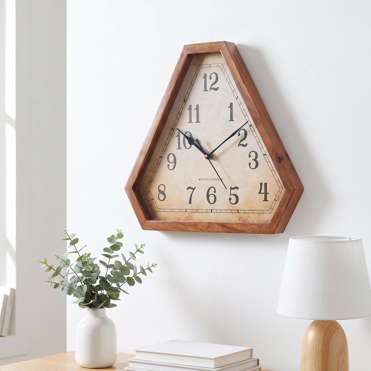 Warm reddish-brown triangular wooden frame with visible grain and clipped corners, close-up