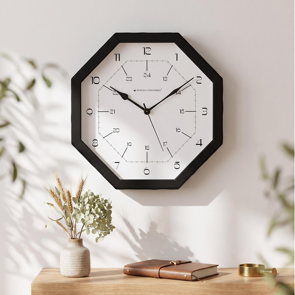 Black octagonal wall clock frame with clean angled edges, close-up view