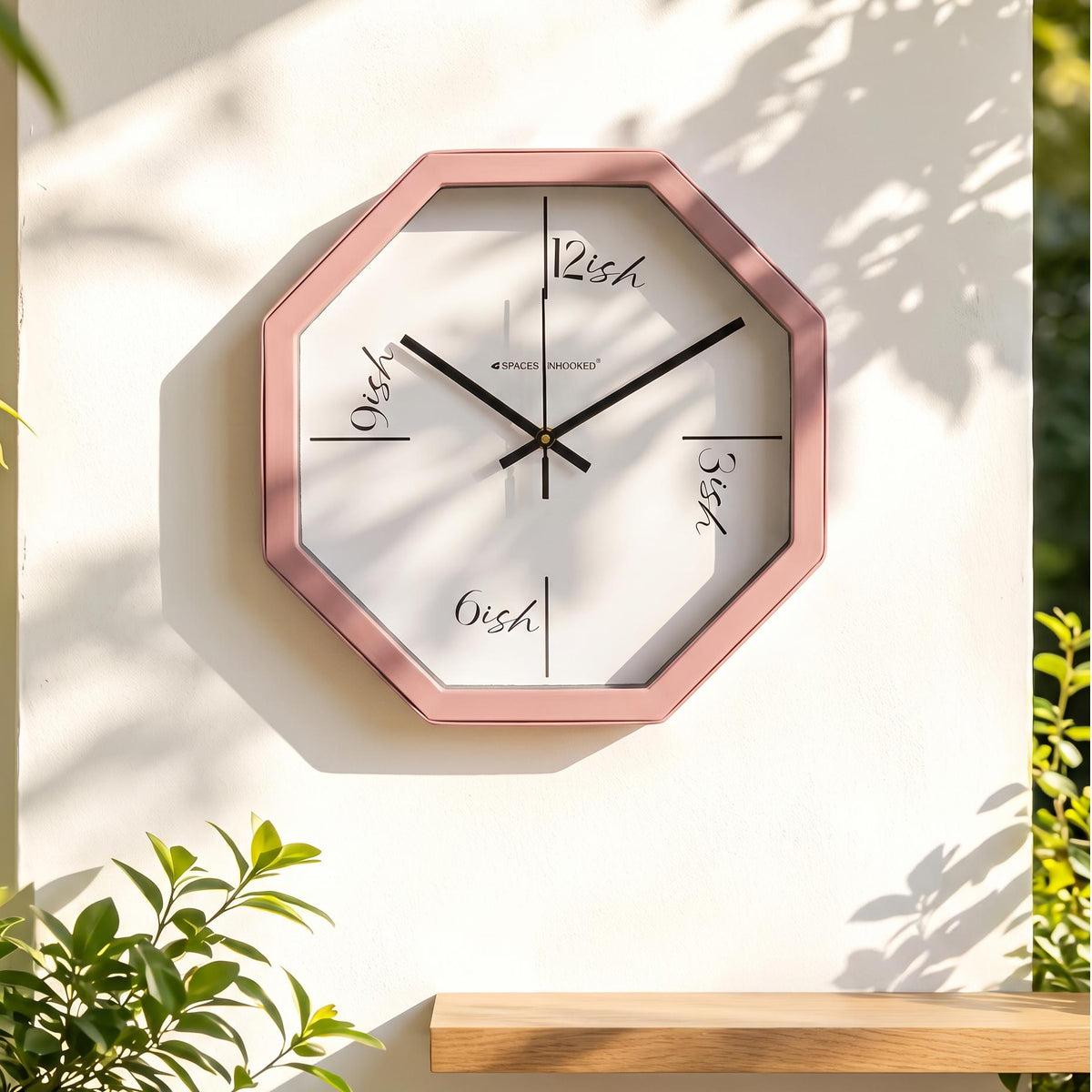 Long line markers at the four main positions on a dusty rose octagonal wall clock