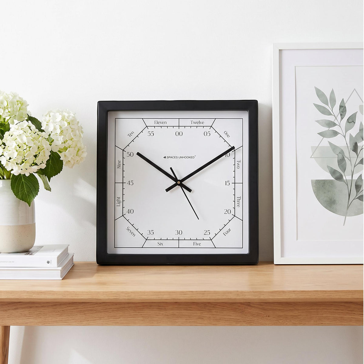 Close-up of large squared-off numerals 1 to 12 on a striped white clock dial