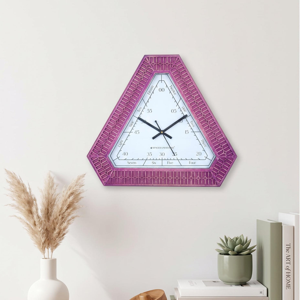 Black hour and minute hands with a thin second hand on a triangular word dial