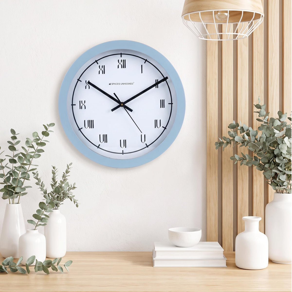Short tick marks at each hour on the fine ring around a Roman numeral wall clock dial