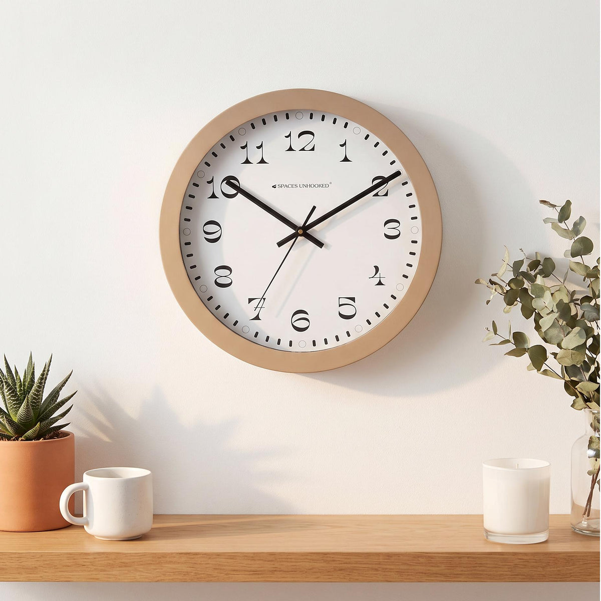 Ring of bold minute dashes and small hour circles on a white round wall clock dial
