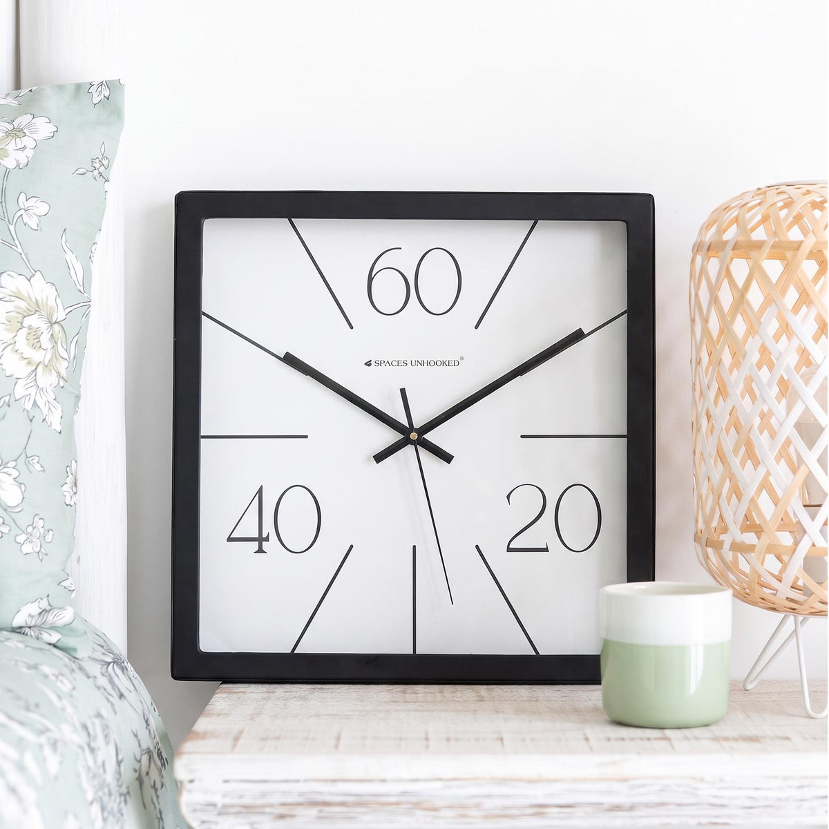 Black square frame and clear cover of a radial line wall clock, close-up view