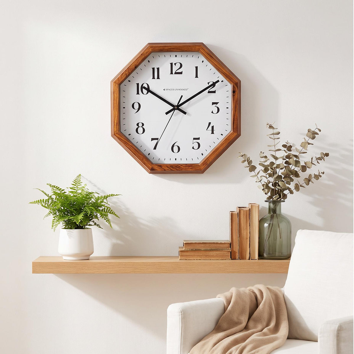 Bold black hands with a thin second hand over large serif numerals on a white dial