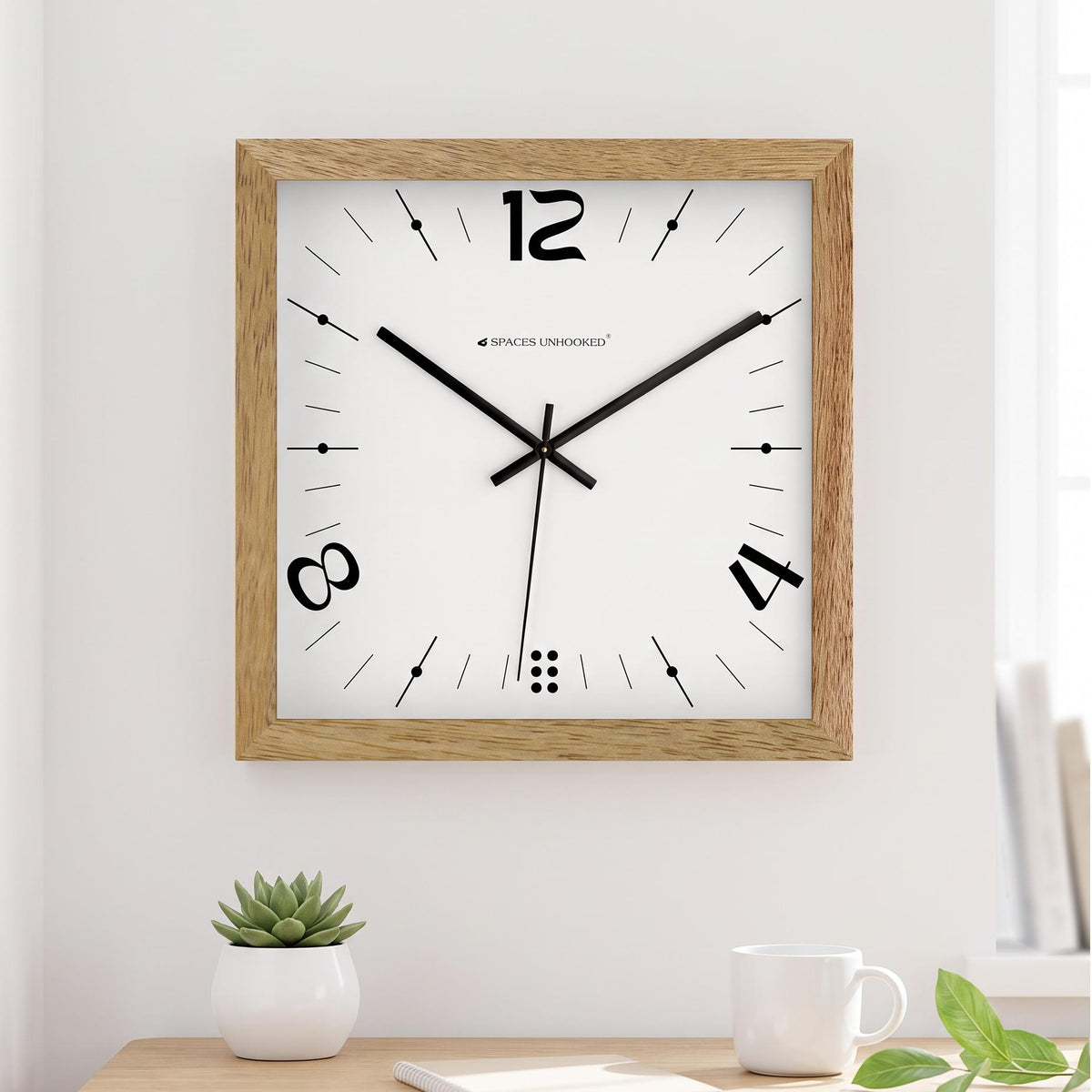 Dot cluster at the base and fine tick markers on a minimal white square clock dial