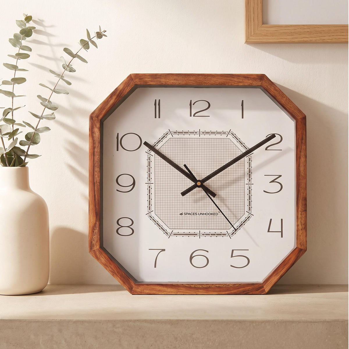 Warm brown octagonal wooden frame with natural grain and cut corners, close-up view