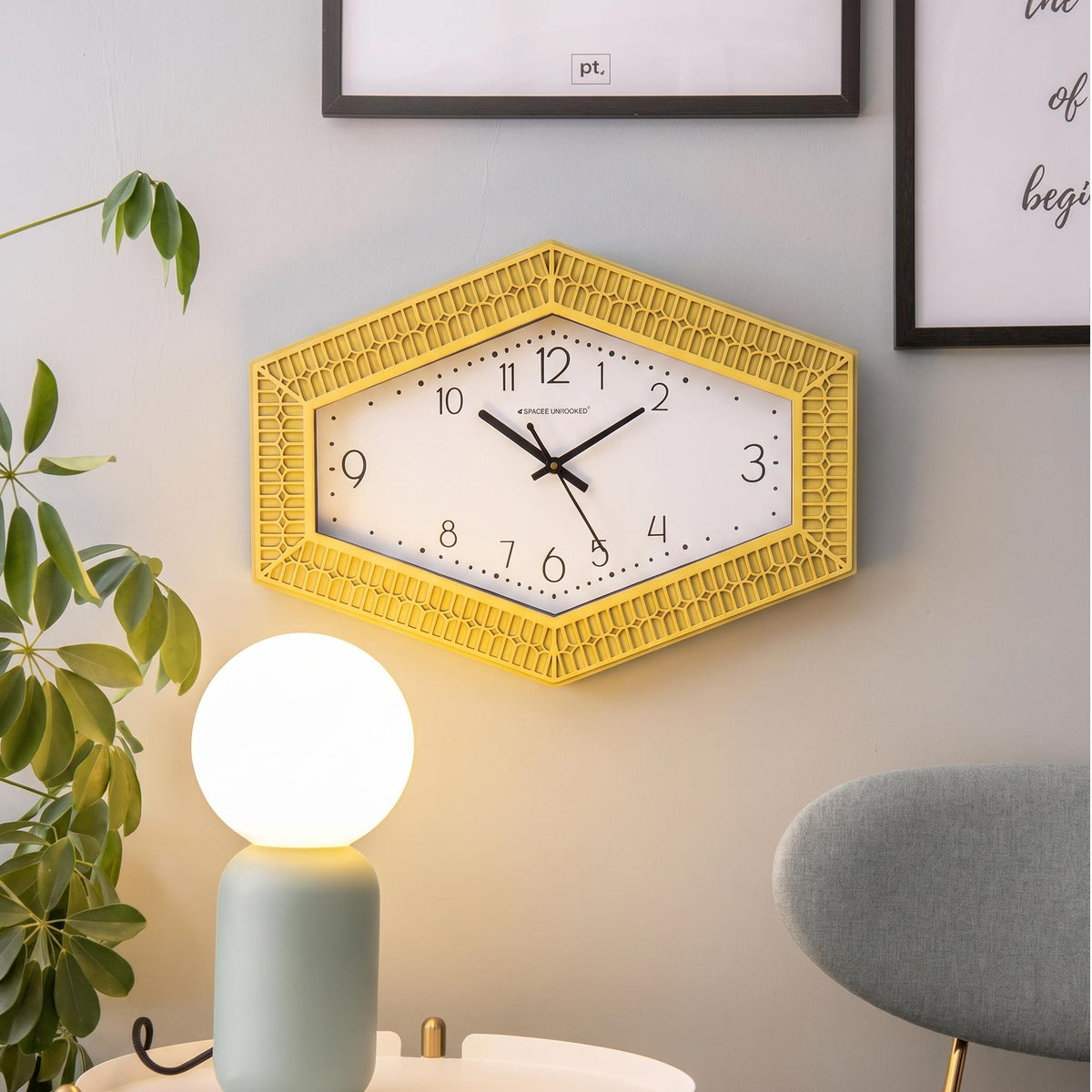 Black hour and minute hands with a thin second hand on a dotted hexagonal dial