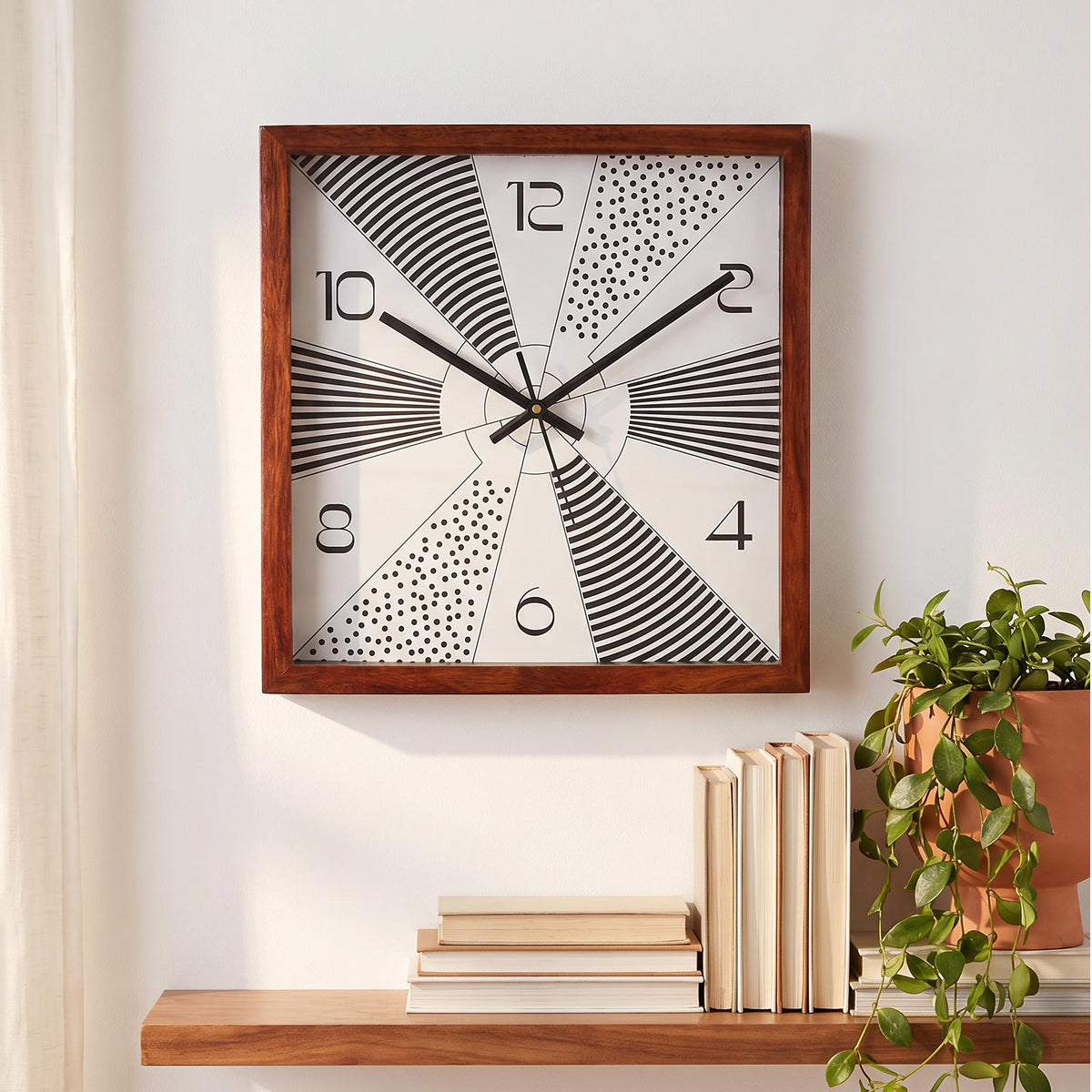 Deep reddish-brown wooden frame with visible grain around a bold geometric clock dial