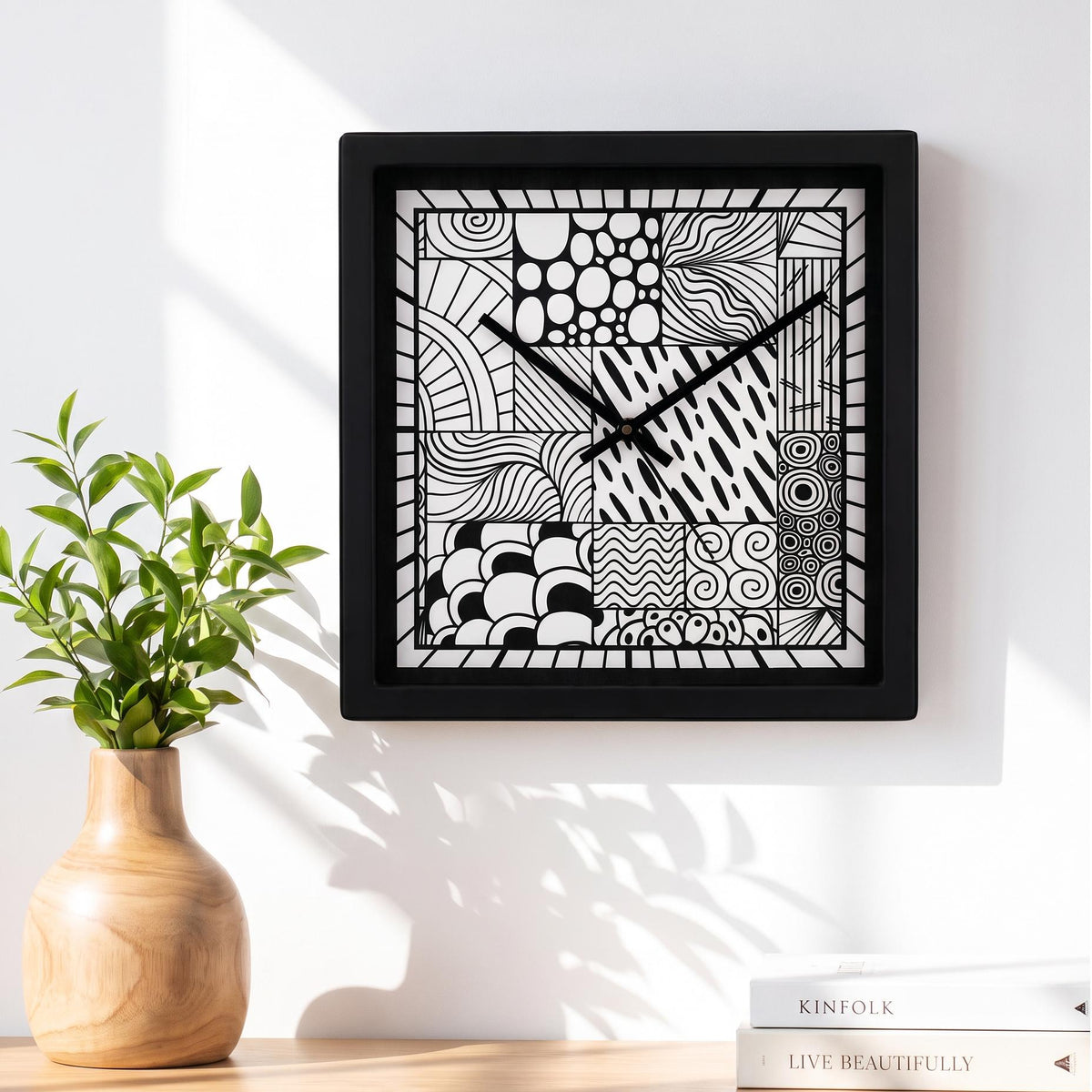 Black square frame and clear cover of a doodle art wall clock, close-up view