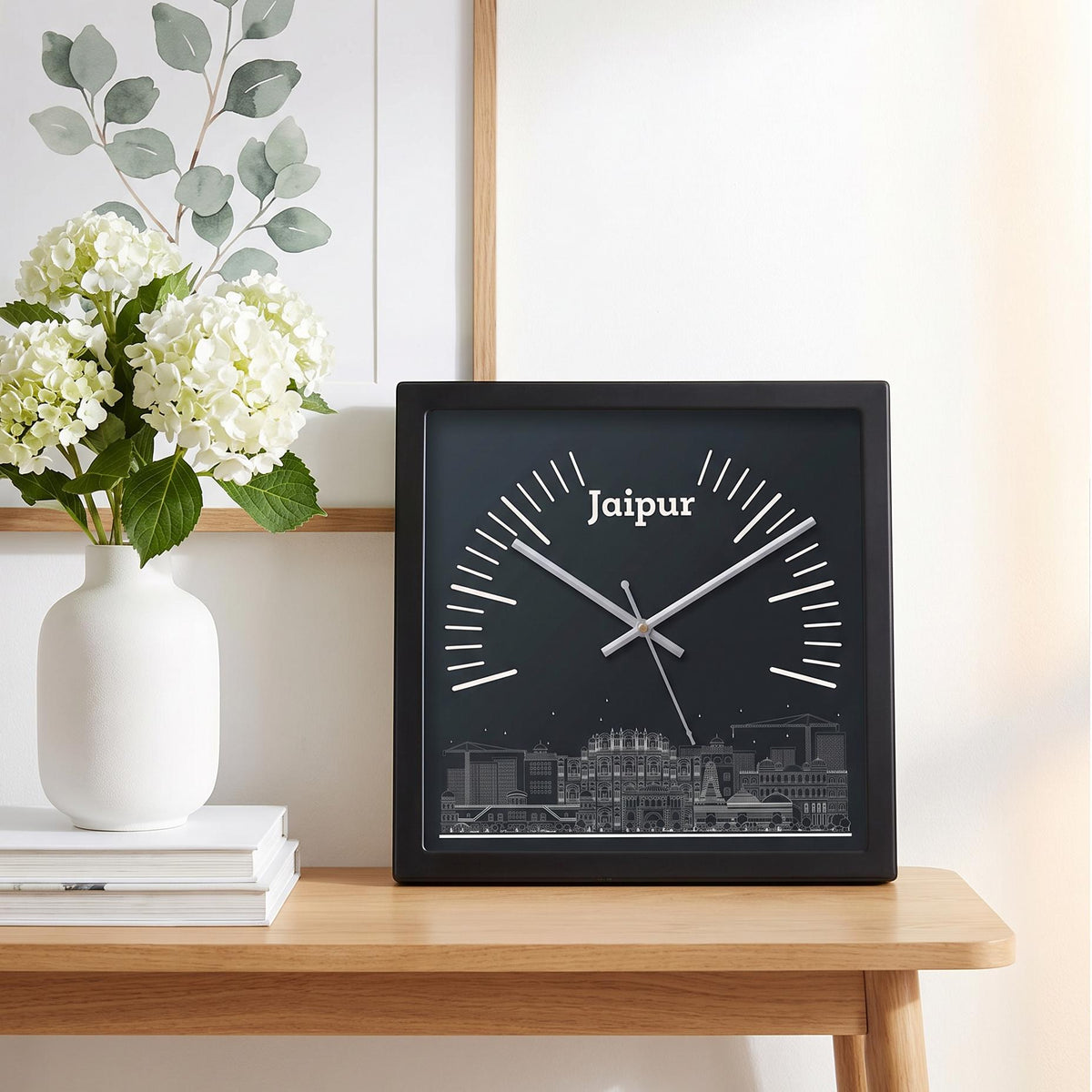 Black square frame and clear cover of a Jaipur skyline wall clock, close-up view