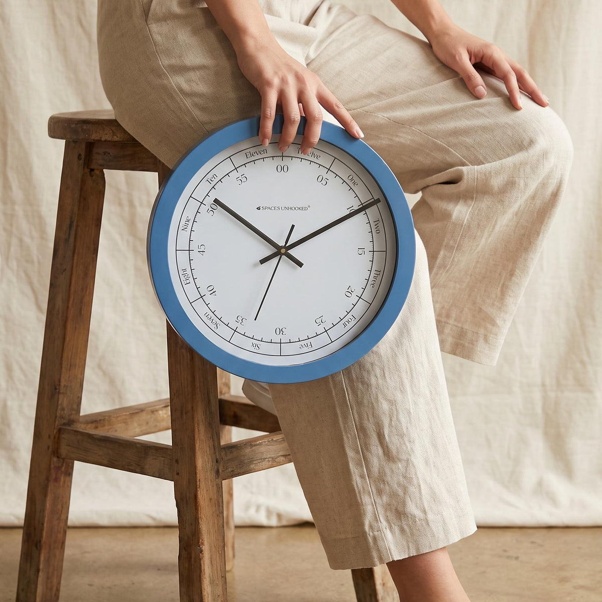 Close-up of hours written as One to Twelve in fine script around a white clock dial